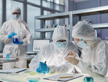 People in protective wear working in the laboratory